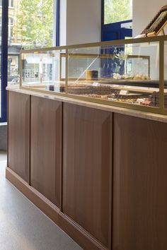 a counter with some food on it in front of a glass door and windows behind it