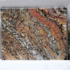 a close up of a marble tile with orange and grey colors on it's surface