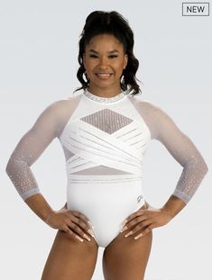 a woman in a white bodysuit posing for the camera with her hands on her hips