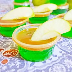 apple slices are placed in small cups on a table