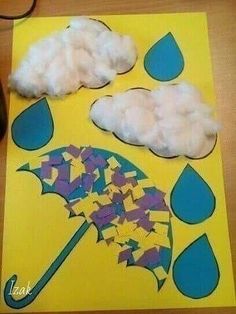 an umbrella and clouds made out of construction paper