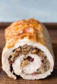 a meatloaf roll cut in half on a cutting board