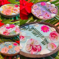 flowers and seashells are floating in a bowl on the beach with palm leaves