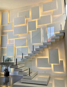 an artistic staircase with white walls and lighting