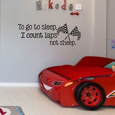 a child's bedroom with cars bed and wall decals