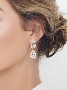 a close up of a woman's face wearing earrings