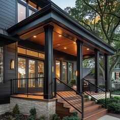 Explore minimalist front porch columns ideas that enhance your home's curb appeal with sleek white columns, rustic wooden columns, and contemporary black metal columns. Discover how each style brings unique charm and sophistication to your front porch design. Modern Porch Posts, Exterior Column Design Ideas, Flat Roof Front Porch, Black House Exterior With Wood Accents, Metal Porch Columns, Porch Post Ideas Columns, Railing On Front Porch, Front Porch Addition Ideas, Columns On Front Porch