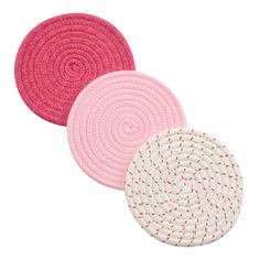 three pink and white rugs are shown on a white background, one is round