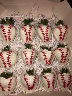 a box filled with chocolate covered strawberries in the shape of baseballs