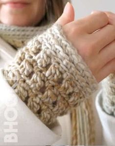 a close up of a person wearing a knitted arm warmer