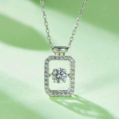 An eye-catching round moissanite dances with ease at the center of this appealing women's necklace, expressing your unstoppable love. Additional round gem set in sterling silver frame the center. Features Moissanite was originally found in meteorites(Chemical name: Silicon Carbide). It was first discovered in 1893, while a scientist was examining meteor samples from a crater in Arizona. After many years, the experts has been recreated moissanite in the laboratory, that make the gemstone with fri Silver Lab Grown Diamond Solitaire Necklace, Diamond Necklace With Center Stone As A Gift, Dazzling Silver Solitaire Necklace With Lab Grown Diamond, Fine Jewelry Diamond Necklace With Center Stone As Gift, Moissanite Necklace With Center Stone In Round Cut, White Gold Diamond Necklace With Center Stone As Gift, Dazzling Necklace With Center Stone For Gift, Dazzling Necklace With Center Stone As Gift, Moissanite Necklace With Center Stone As Gift