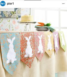 an easter bunting banner with white rabbits on it and carrots in the background