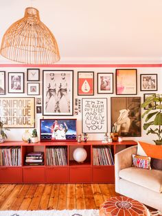 a living room filled with furniture and pictures on the wall