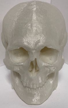 a white plastic skull is shown on a table