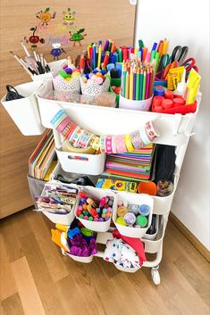 a white cart filled with lots of craft supplies