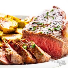 steak, potatoes and green beans on a white plate