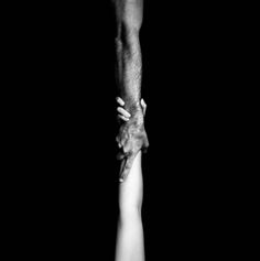 two people holding hands in the middle of each other's arms, black and white photograph