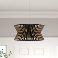 a wooden light fixture hanging from the ceiling in a room with white walls and doors