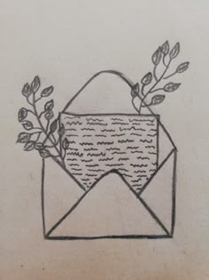 an envelope with some leaves on it and a piece of paper sticking out of it