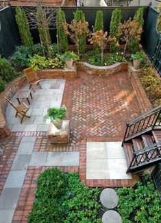 an aerial view of a courtyard with stairs and seating area in the foreground, surrounded by greenery