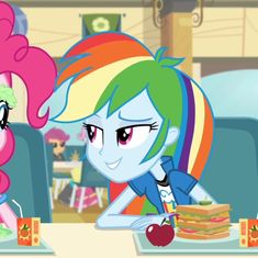 two ponies are sitting at a table with food in front of them and one is eating