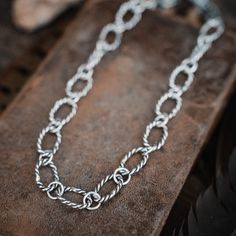 Handforged into twisted links of sterling silver, this chunky chain necklace is acowgirl's dream. So saddle up and rock it for a wild western look! Yeehaw! 18-19" adjustable Chunky chain necklace Mariner Chain links Hand forged Made by hand and heart Silver Chunky Chain Necklace In Sterling Silver, Chunky Chain Link Metal Necklace, Artisan Silver Necklaces For Western-themed Events, Silver Metal Western Necklace, Artisan Silver Necklace For Western-themed Events, Bohemian Silver Necklace With Chunky Chain, Bohemian Silver Chunky Chain Necklace, Silver Multi-strand Chunky Chain Necklace, Chain Silver Necklace