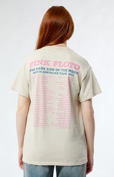 a woman wearing a pink floyd t - shirt with the band's dates printed on it