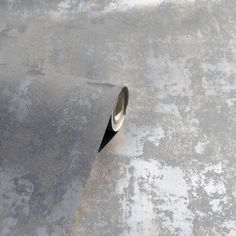 a roll of duct tape sitting on top of a cement floor