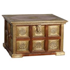 an ornately decorated chest with gold and wood decoration on the front, side view