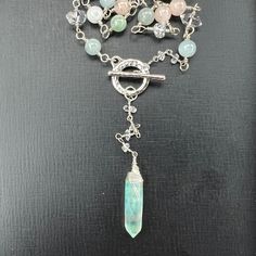 This Herkimer diamond, Aquamarine and aqua aura quartz crystal point lariat necklace with a sterling silver toggle clasp will bring some sparkle to any outfit.  Dripping in gorgeous AA quality large Herkimer diamonds, Aquamarine, pretty pastel pink and green colored round Quartz stones, this sterling silver wire wrapped necklace was made with love and attention to detail! The front of the necklace has a 1 1/2'' aqua aura Quartz Crystal point wrapped in Sterling silver wire.  A shiny hammered Ste Wire Wrapped Crystal Necklace, Wrapped Crystal Necklace, Silver Lariat Necklace, Couleur Rose Pastel, Blue Aura Quartz, Lariat Necklace Silver, Aqua Aura Quartz, Blue Aura, Aqua Aura