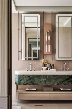 a bathroom with marble counter tops and mirrors