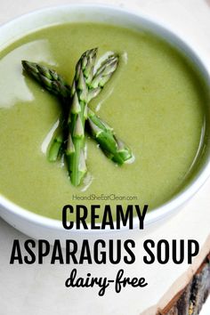 creamy asparagus soup with dairy - free cream in a white bowl on a table