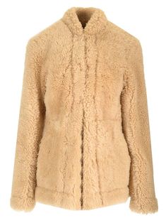 Natural beige shearling coat from Toteme, with a slightly fitted silhouette, reverse lapel collar, low pockets. Beige Faux Fur Lined Coat For Work, Beige Faux Fur Coat For Workwear, Classic Beige Fur Coat With Faux Fur Lining, Totême Shearling Jacket, Luxury Classic Shearling Outerwear, Toteme Embroidered Scarf Jacket, Designer Shearling Long Sleeve Outerwear, Luxury Shearling Outerwear With Button Closure, Versace Designer