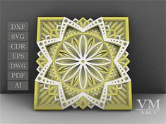 an intricate paper cut design in yellow and white