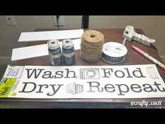 a sign that says wash off fold dry repeat and some craft supplies on a table