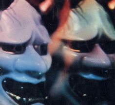 two blue and one pink masks are shown in front of each other with their mouths open