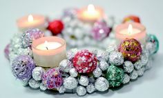 a bracelet made out of candy balls and lit candles