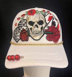 a white hat with a skull and roses on it