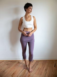 Comfortable, fashionable, breathable leggings to show off your hard work. Made with soft, long-lasting, light, stretchy fabric, these pants are perfect for Yoga and Casual day wear. Can be sold separately or as shown, with a cute matching stretchy mini skirt to accentuate your curves. Paired with Shanti Strappy Yoga Tank Bra in White. Shown here in Amethyst with matching Mini Skirt. Skirt sold together or separately. Handwash or machine wash on Delicate. Hand Dry Fitted Yoga Pants With Elastic Waistband For Gym, Fitted Yoga Pants With Elastic Waistband For Workout, Fitted Athleisure Yoga Pants With Elastic Waistband, Tight Yoga Pants With Elastic Waistband For Pilates, Yoga Leggings With 4-way Stretch, Fitted Activewear With Elastic Waistband For Light Exercise, Stretch Yoga Pants With Elastic Waistband For Pilates, Versatile Tight Yoga Bottoms, Versatile Fitted Yoga Pants With Elastic Waistband