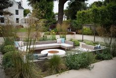 an outdoor seating area surrounded by plants and trees