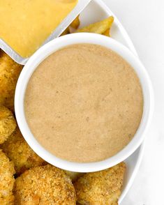 a white plate topped with tater tots and dipping sauce