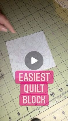 someone is using scissors to cut out a piece of paper with the words easier quilt block on it