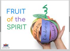 a hand holding an apple with the words fruit of the spirit taped to it's side