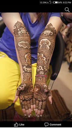 a woman with her hands covered in henna