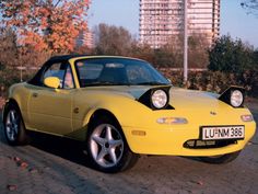 a yellow sports car parked on the street