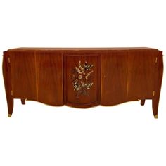 an art deco sideboard with flowers and leaves painted on the doors, inlaid to wood