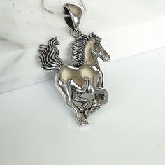 ▪︎ ONE sterling silver horse charm. ▪︎ Size: 27 X 37(Including hoop) mm Weight: 6.7 gm ▪︎ This multi purpose pendant can be used as a charm in necklaces, bracelets, key chains, zip pullers etc. ▪︎ This pendant is handmade with hypoallergenic sterling silver. Most of my pieces are marked with a 925 silver stamp. ▪︎ Please note: This listing is for ONE pendant and comes WITHOUT the chain, however, you can add a snake chain in the required length while making your selection. You can also opt to cho Unique Horse Design Jewelry Gift, Unique Horse Design Jewelry For Gift, Collectible Silver Horse Design Jewelry, Silver Jewelry With Horse Design In Round Pendant, Horse Design Pendant Jewelry Gift, Horse Bracelet, Wanderlust Jewelry, Horse Pendant, Horse Necklace