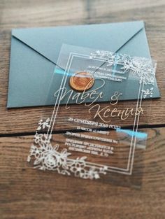 an envelope and some cards on a wooden table