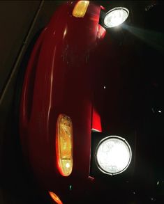 the front lights of a red sports car