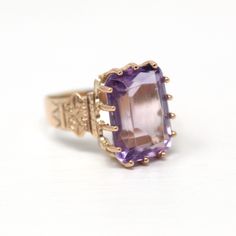 Gorgeous antique circa 1890s Victorian era 10k rosy yellow gold genuine amethyst ring! This stunning ring features a rectangular faceted 7 carat genuine amethyst gemstone, that is securely prong set. There are intricate designs down the tapered shoulders. An exquisite piece of fine Victorian era jewelry, featuring February's birthstone!   ERA - Circa 1890s / Victorian Era METAL / MATERIAL - 10k rosy yellow gold, genuine amethyst (approx. 7 carats) MARKINGS / HISTORY - N/A CONDITION - Good antique condition. Gold metal has been professionally polished & cleaned. Genuine gemstone is secure, with only light age consistent surface wear. All prongs have been rebuilt by our jeweler, and the ring has been professionally refurbished.  SIZE / MEASUREMENTS - Size: 6, Ring Head Height: 15.8 mm, Rise Vintage Yellow Gold Hallmarked Amethyst Ring, Antique 14k Gold Amethyst Ring, Vintage Yellow Gold Amethyst Ring, Heirloom Style Purple Amethyst Collectible Ring, Heirloom Purple Amethyst Collectible Ring, Victorian Amethyst Ring In Yellow Gold, Antique Yellow Gold Amethyst Ring, Antique Amethyst Jewelry Stamped 14k, Victorian Yellow Gold Amethyst Gemstone Ring